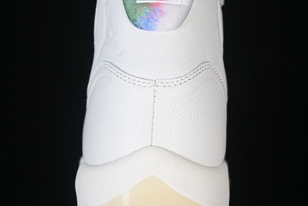 Rear view highlighting the white heel and colorful collar.