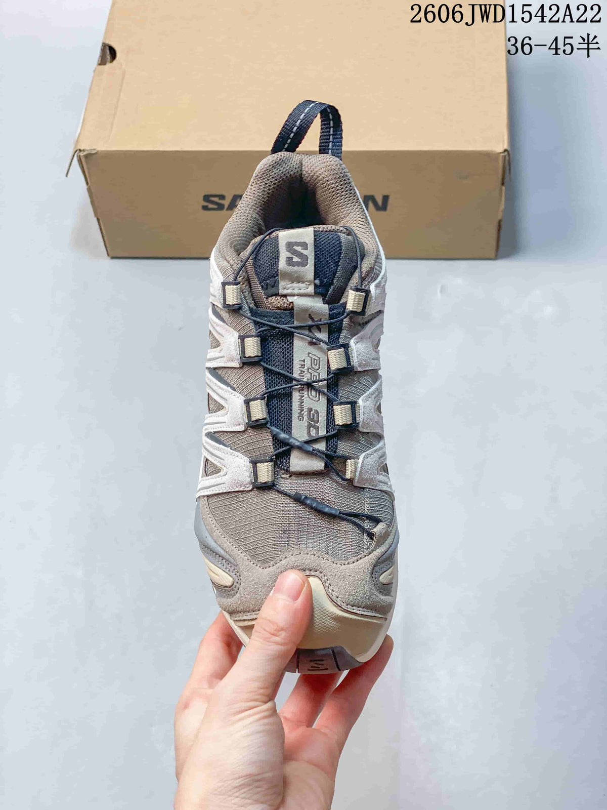Front view highlighting the quick-lacing system and layered upper of a Salomon sneaker.