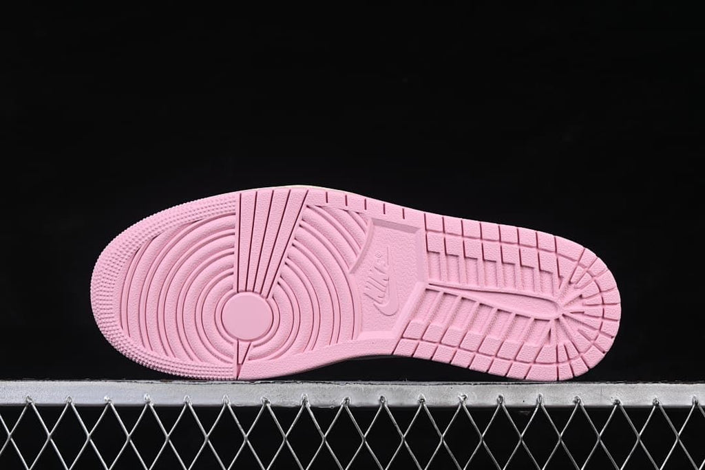 Pink outsole with circular forefoot tread and patterned grooves
