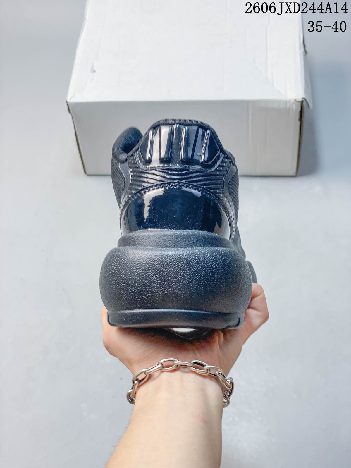 Rear view of a charcoal sneaker with a chunky sole and layered heel details.