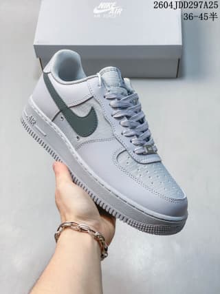 Angled three-quarter view showing the perforated toe, dark green Swoosh, laces, and padded collar.