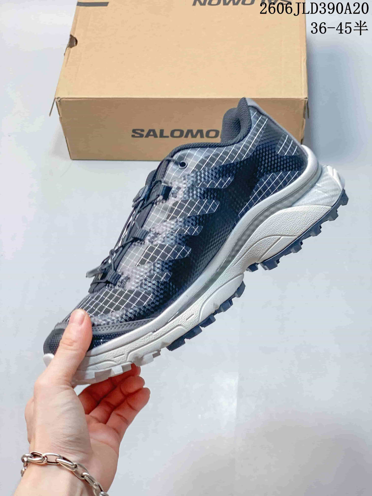 Side view of the patterned shoe with quicklace-style closure and lugged outsole.