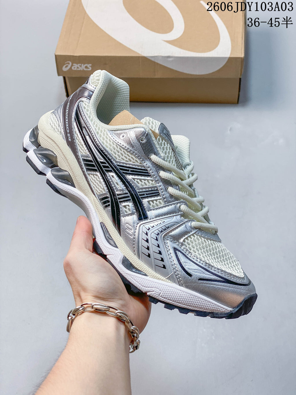 White and silver ASICS GEL-KAYANO 14 sneaker with dark detailing