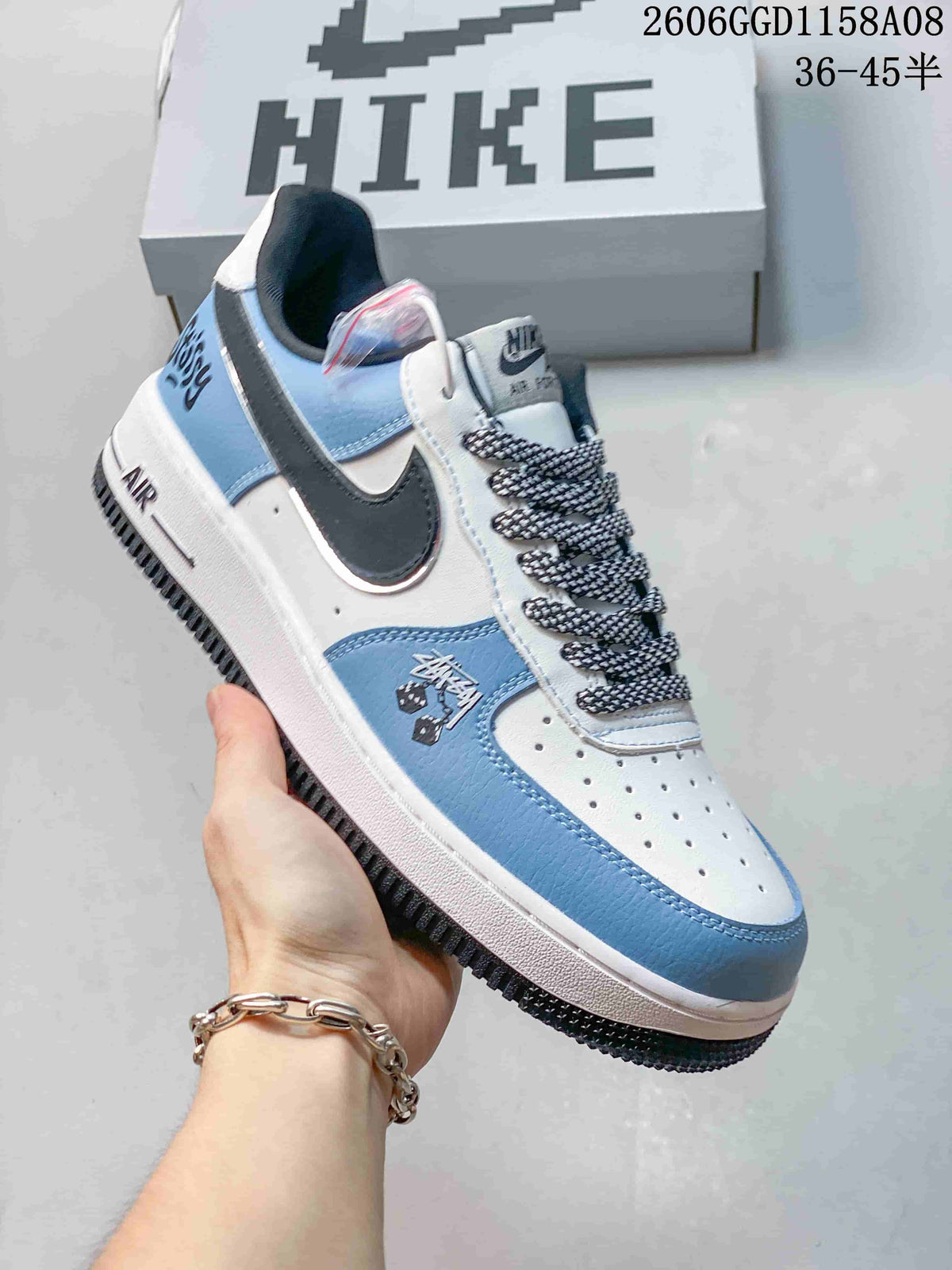 Angled view of the sneaker's white and blue panels, dark side accent, and patterned laces