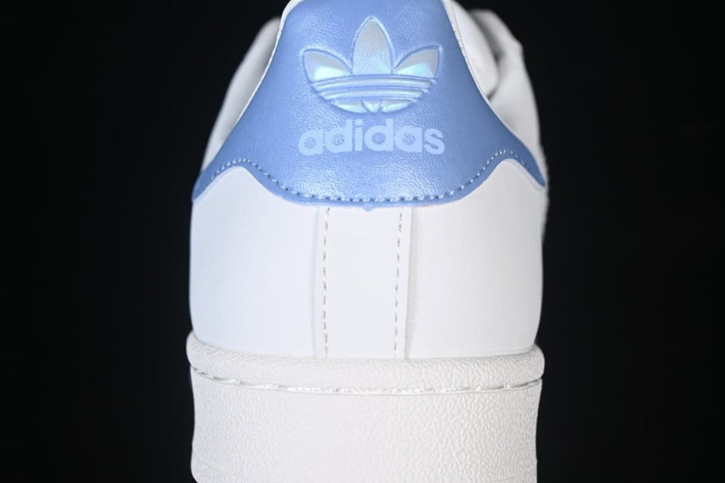 Rear view of the sneaker with pale blue heel panel and adidas Trefoil branding.