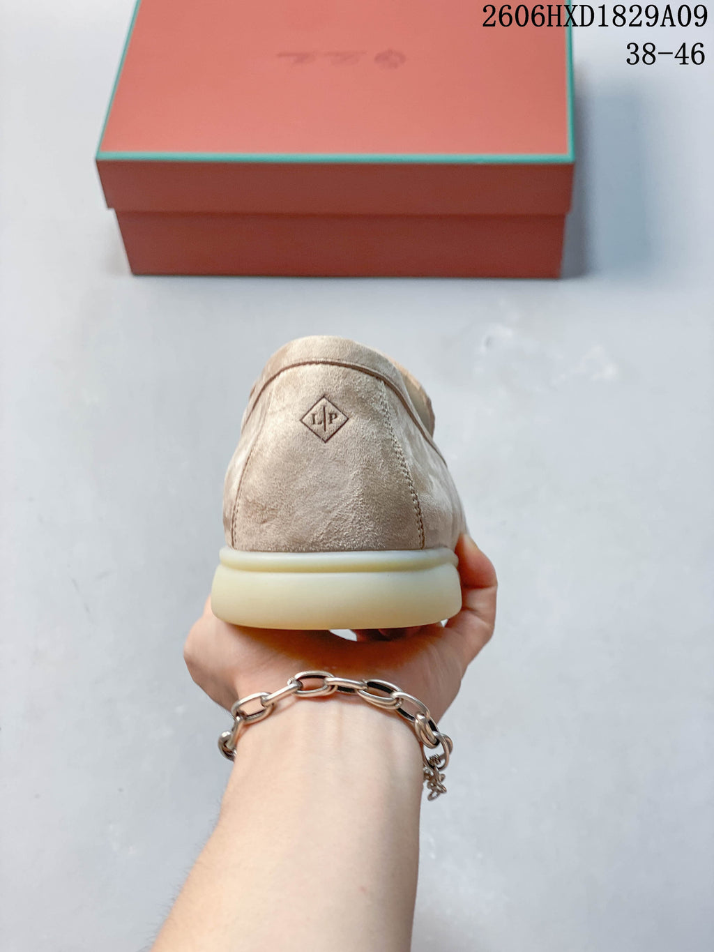 Rear view of a beige loafer with an LP heel mark