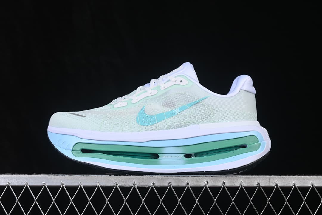Side view of a pale mint and light blue Nike Vomero Premium shoe