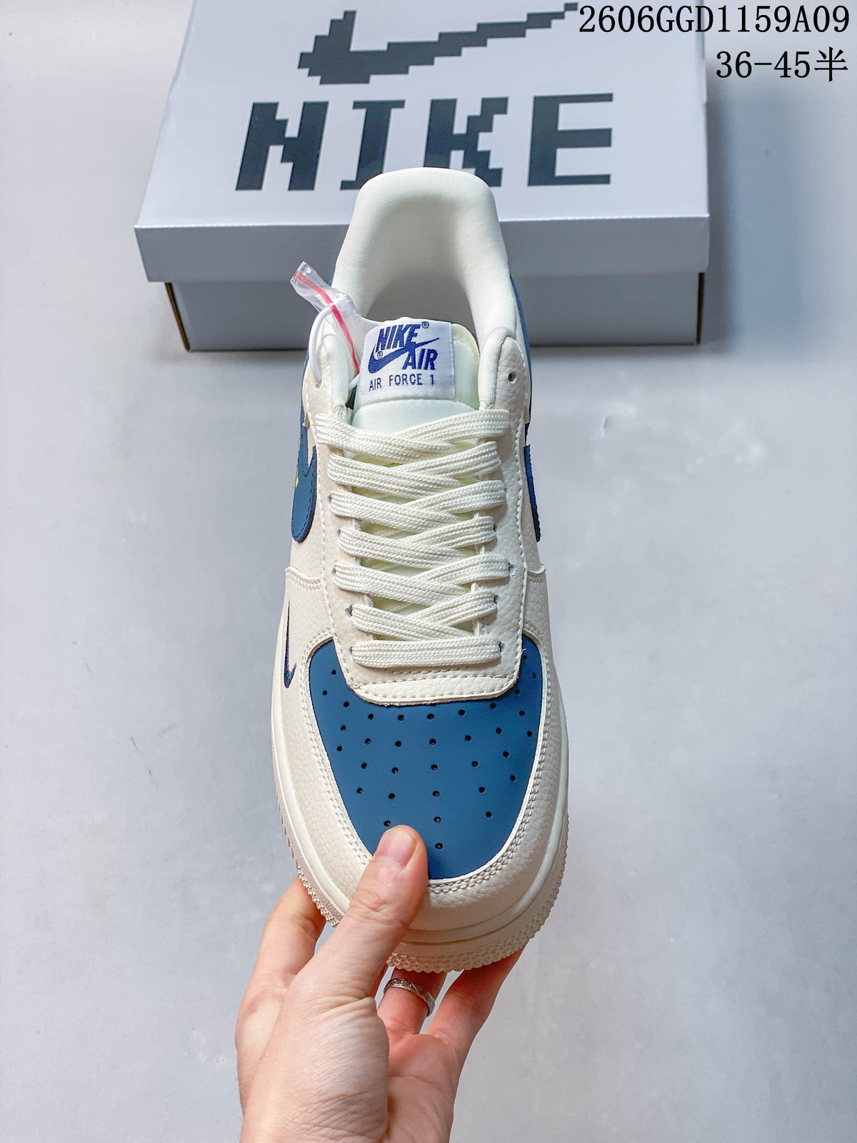 Front view showing the perforated blue toe, laces and tongue label