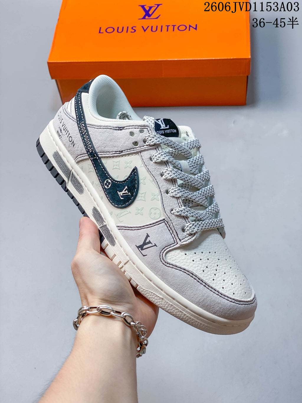 Light gray and navy low-top sneaker with perforated toe and patterned side panel