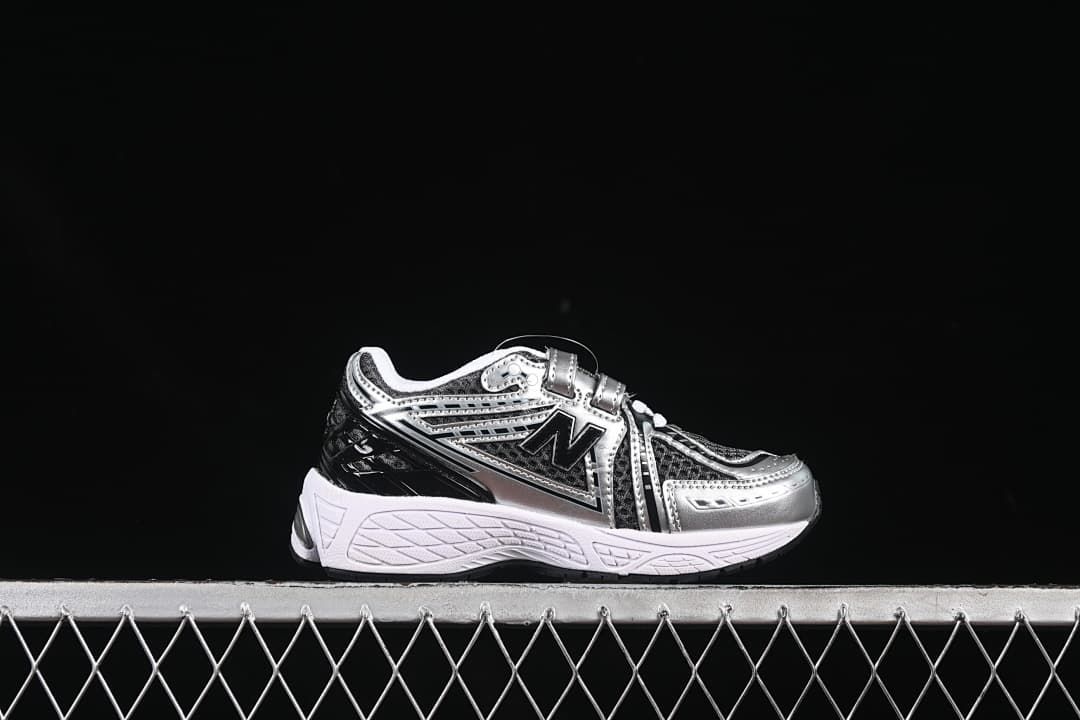 Side profile of a silver and black kids sneaker with hook-and-loop strap