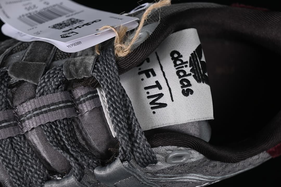 Close-up of the shoe tongue with adidas and S.F.T.M. branding.