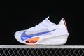 Side view of a white Nike running shoe with a large blue Swoosh and orange forefoot accent.