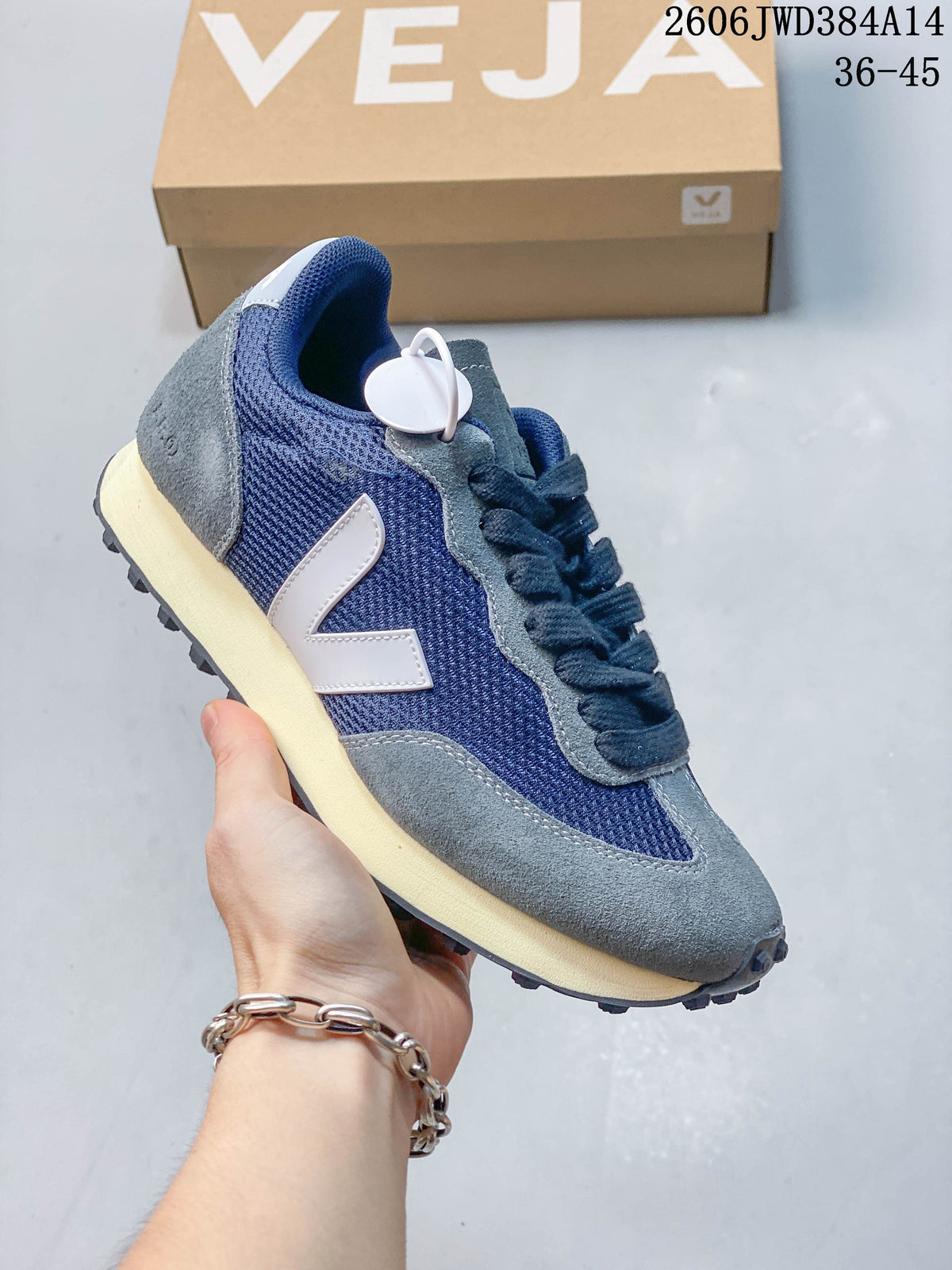 Angled side view of the navy and grey low-top sneaker