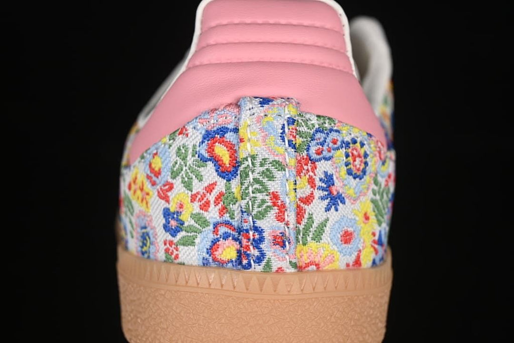 Rear close-up of floral heel panel, pink heel tab and gum outsole.