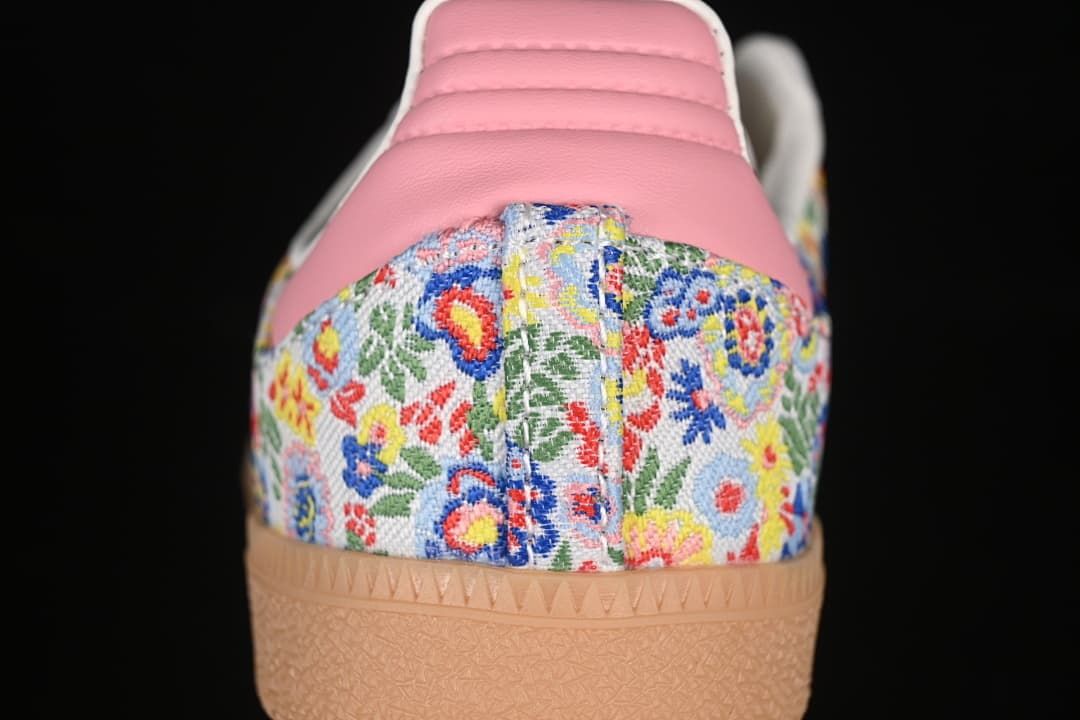 Rear close-up of floral heel panel, pink heel tab and gum outsole.