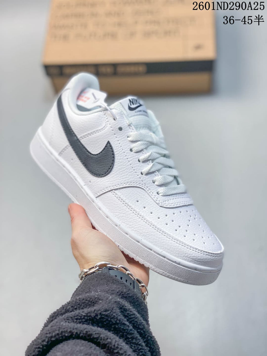 Angled side view of a white Nike Court Vision sneaker with a dark Swoosh