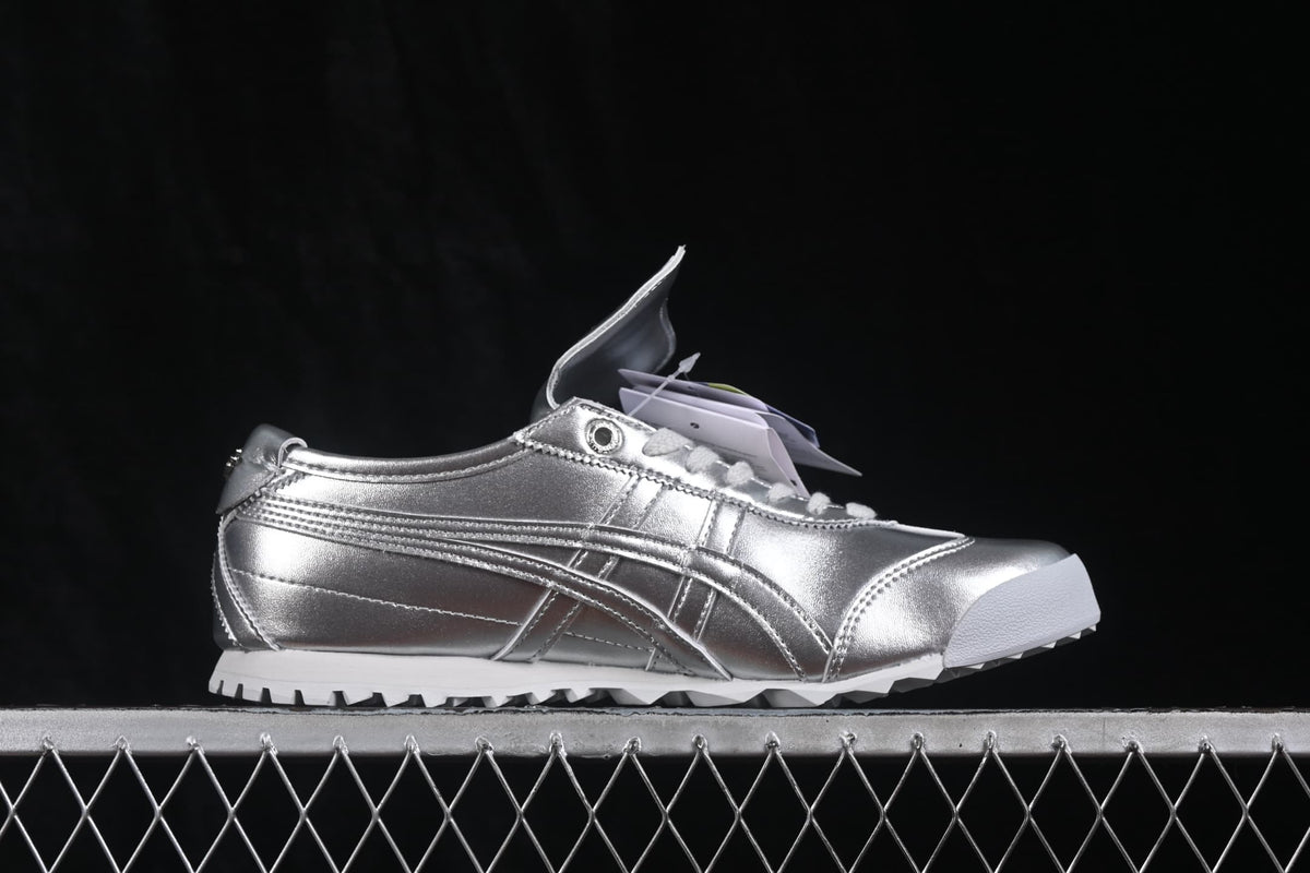 Side profile of a silver Onitsuka Tiger Mexico 66 Golf sneaker with tonal side stripes and white outsole.