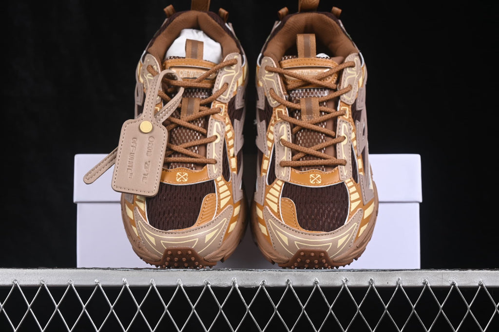 Top view of brown and cream Off-White sneakers with dark mesh, brown laces, layered panels and a hangtag.