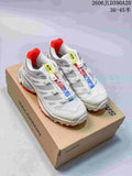 Pair of white and gray Salomon XT-4 OG shoes with red accents, shown on a branded shoe box.