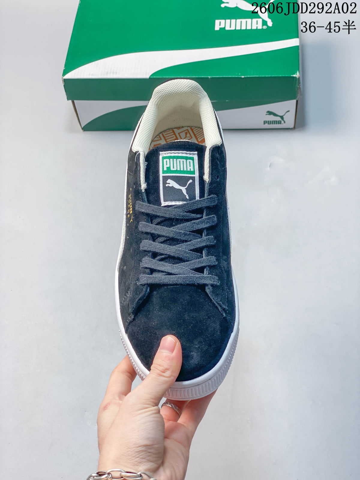 Top view of a navy Puma sneaker with lace-up closure and branded tongue.
