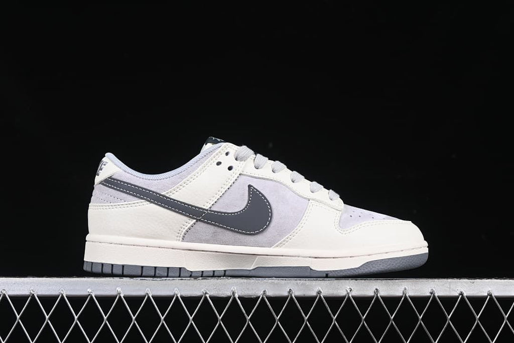 Outer side profile of a low-top sneaker with grey Swoosh