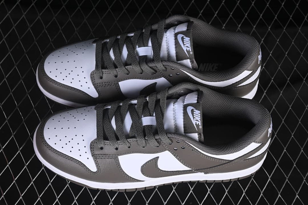Top view of a pair of grey and white Nike SB Dunk Low sneakers