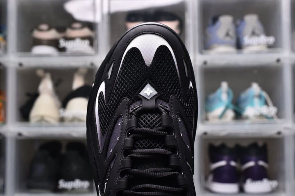 Top-down close-up of the black mesh toe and laces
