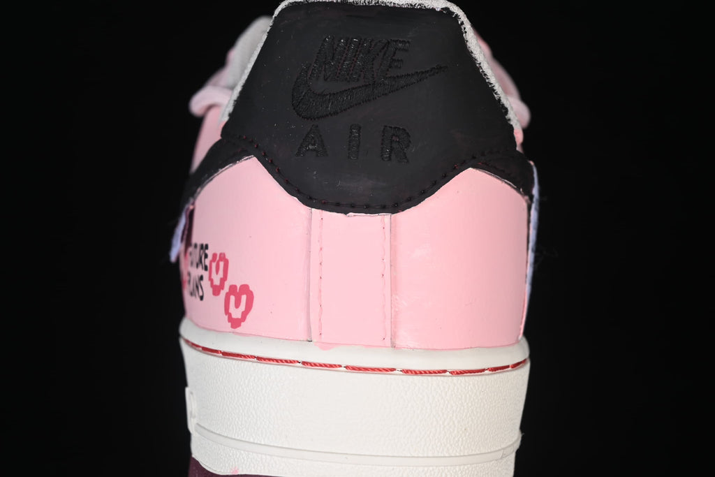 Close-up of black heel tab and pink heel panel