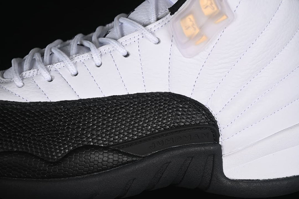 Close-up of the textured black mudguard and white stitched upper.