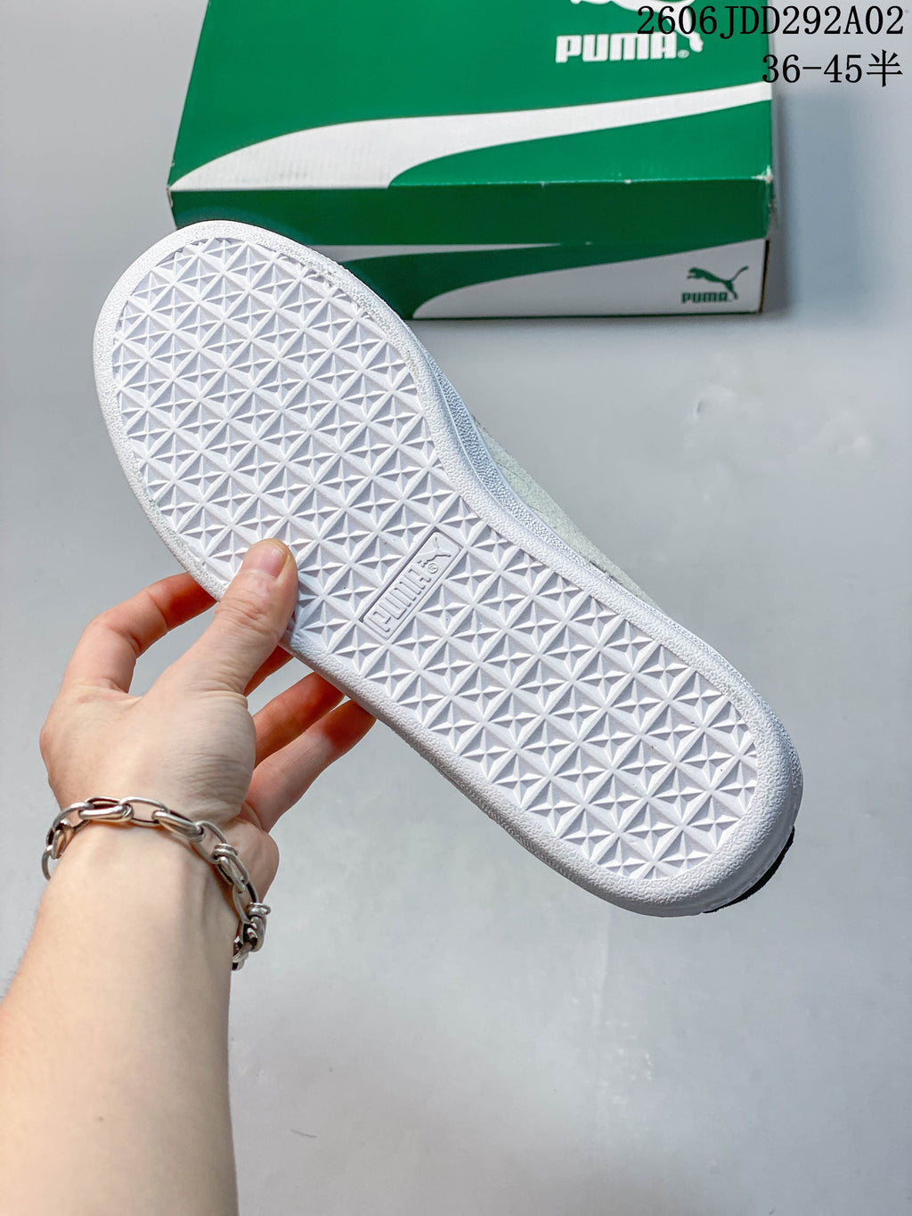 Close-up of the white geometric tread on the sole of a Puma sneaker.