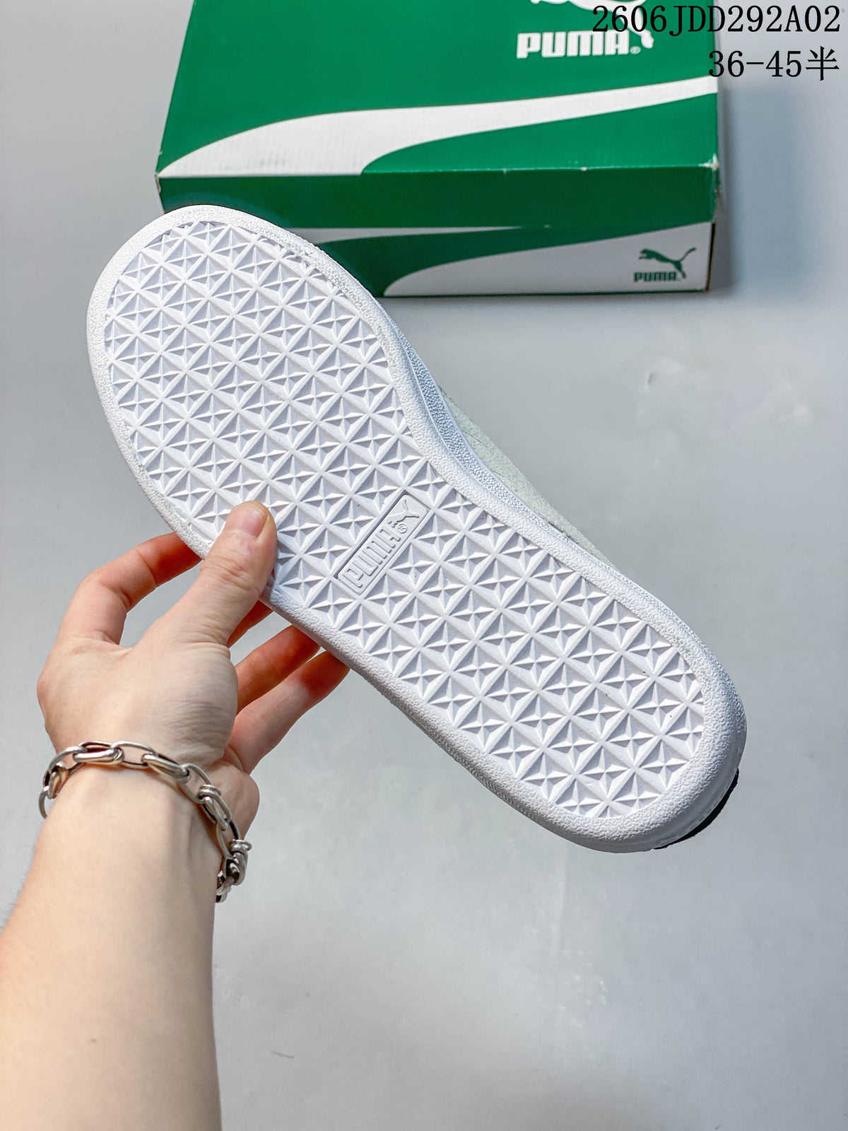 Close-up of the white geometric tread on the sole of a Puma sneaker.
