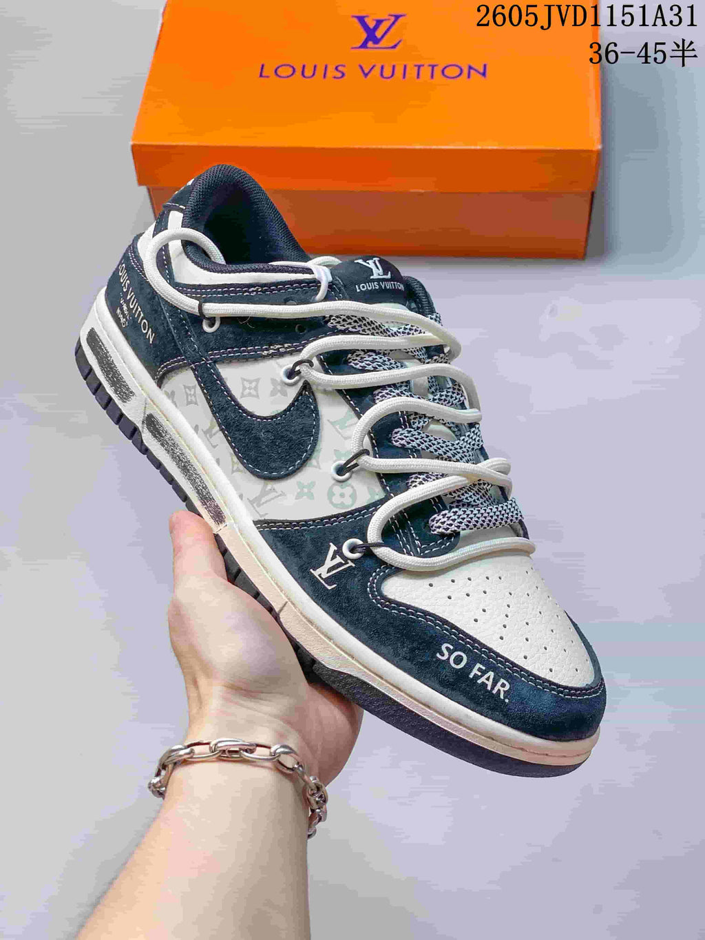 Angled view of a navy and white sneaker with patterned side panels and contrasting overlays.
