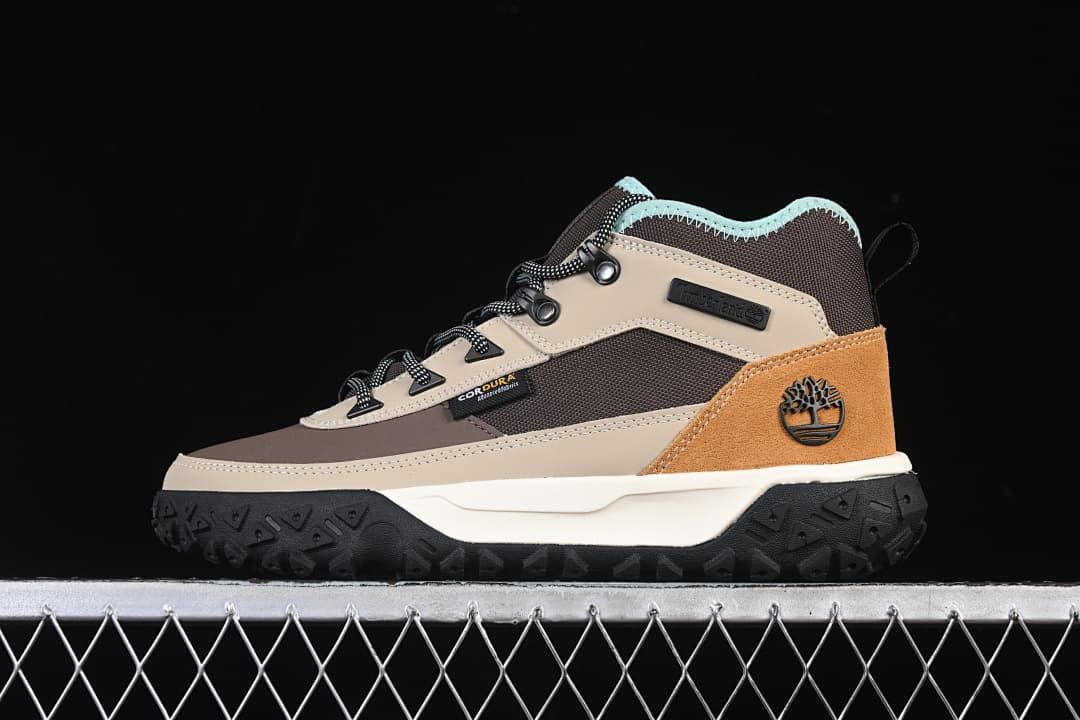 Side view of a brown, gray, and tan Timberland mid boot with black outsole