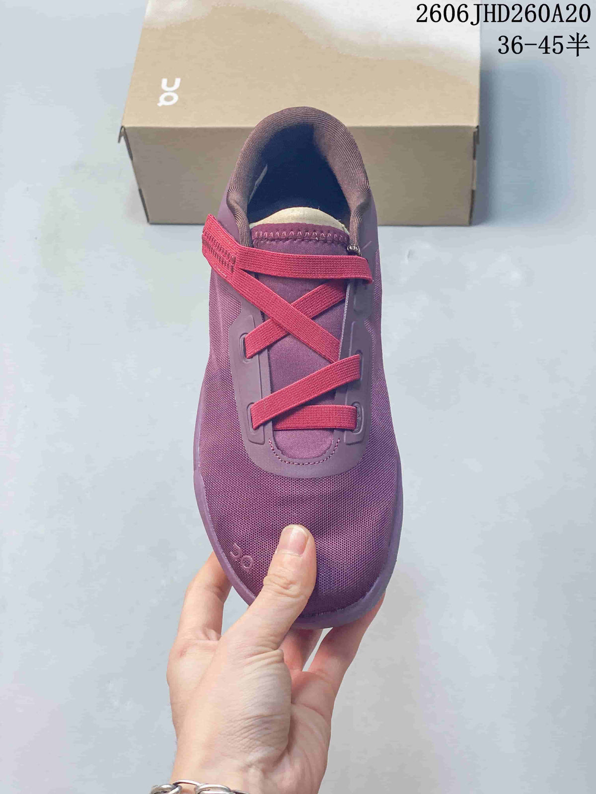 Top view of the purple shoe with bright red lace bands