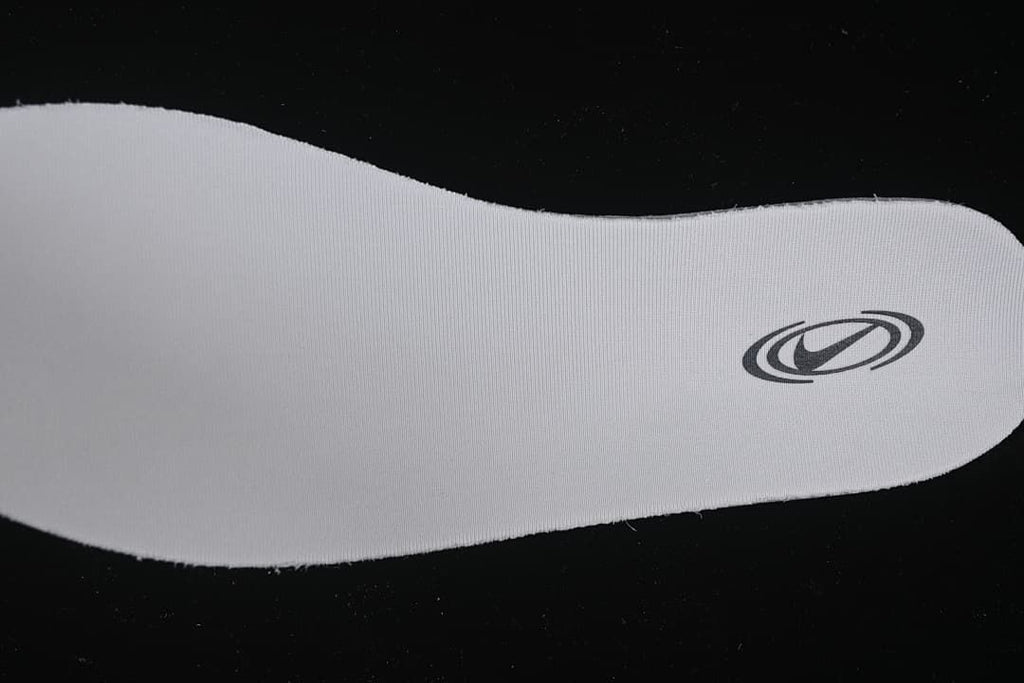 Close-up of a white insole with a dark oval logo.
