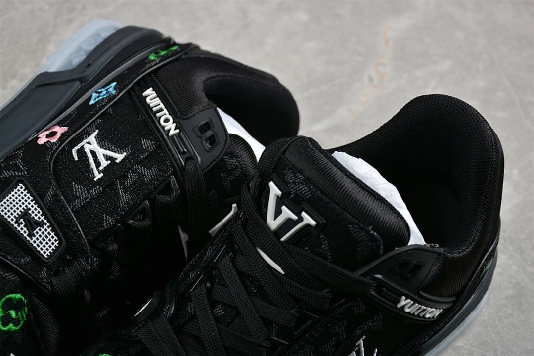 Close-up of the patterned black upper, laces, and tongue branding