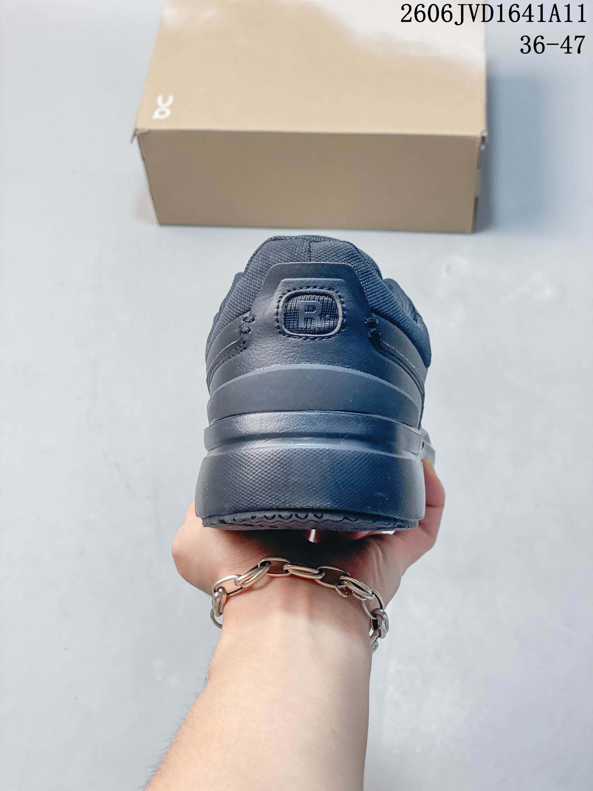 Rear view of a slate-blue sneaker with a tonal heel logo