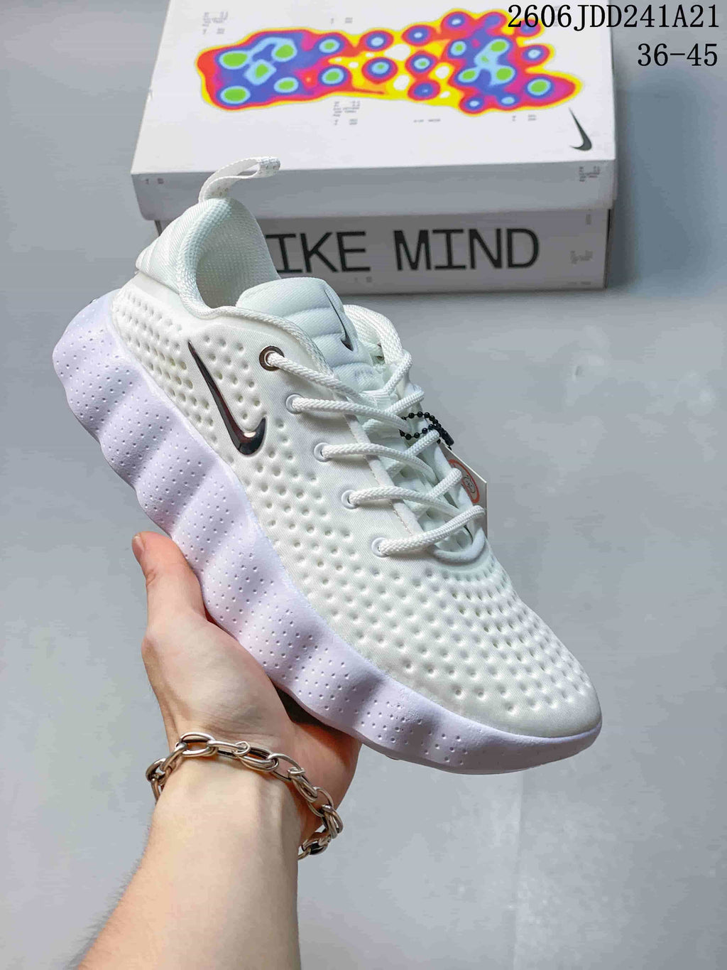 White Nike Mind 002 SP FK shoe with a dimpled upper and thick pale outsole.