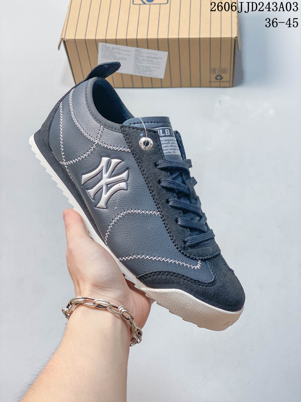 Side view of a navy sneaker with New York Yankees branding and contrast stitching