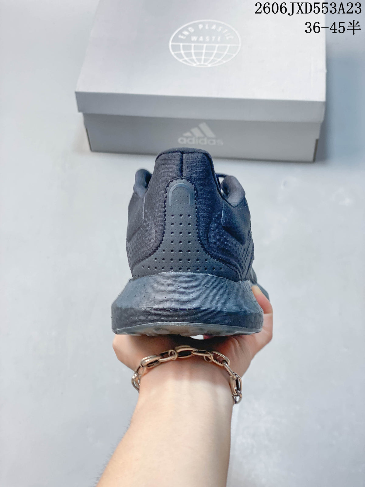 Rear view showing the heel and midsole of a charcoal Adidas PureBoost 21 shoe.