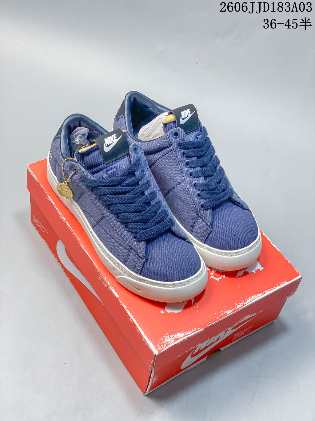 Pair of blue Nike x Devin Booker Blazer sneakers shown on a red shoebox