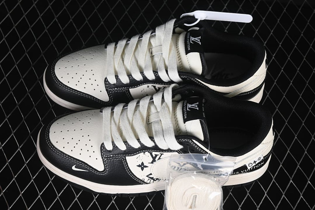 Overhead view of a pair of cream and black low-top sneakers with white laces and printed side panels