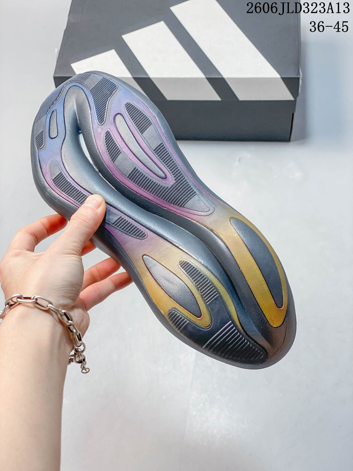 Close-up of the patterned outsole on the gray sneaker.