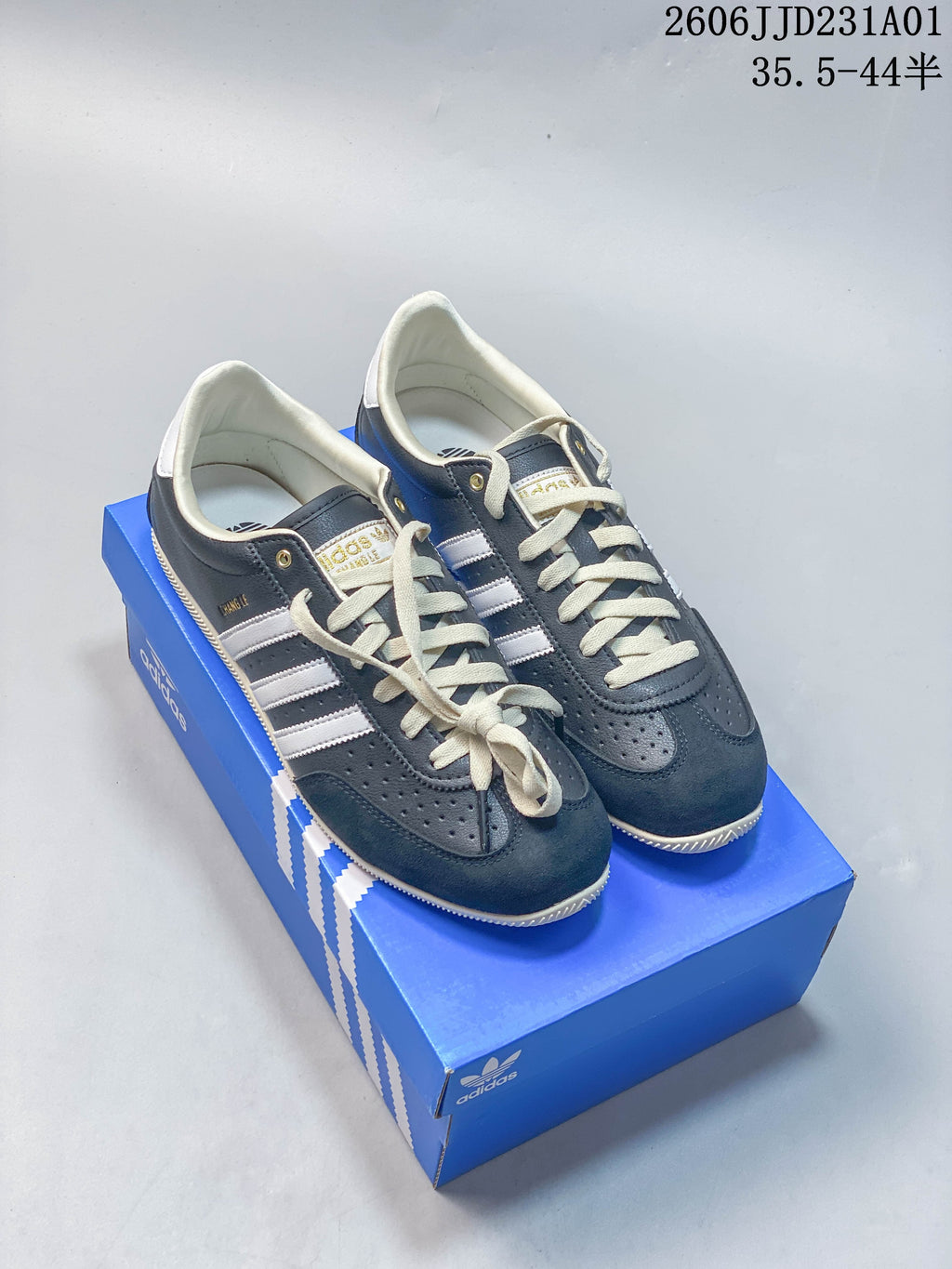 Pair of navy Adidas Changle low-top sneakers with light-colored stripes and laces.