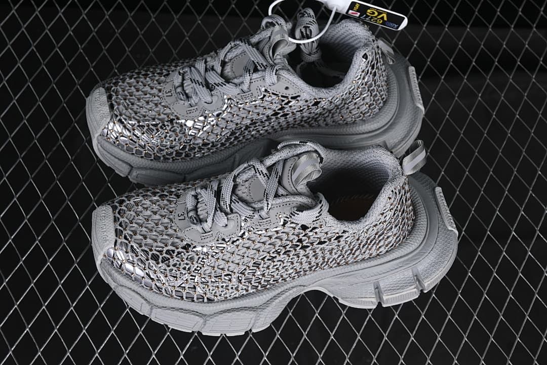 Pair of grey openwork sneakers photographed from above and the side.