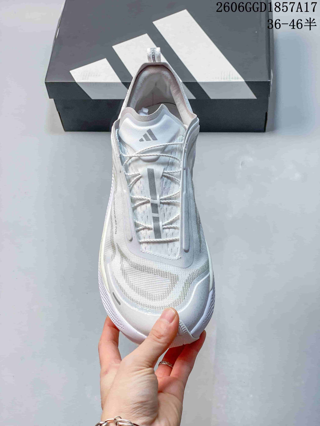 Top view of a white Adidas shoe with lace-up closure