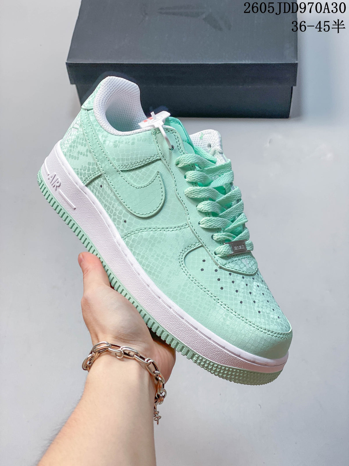 Side view of a mint Nike Air Force 1 ’07 sneaker with a patterned upper and white midsole