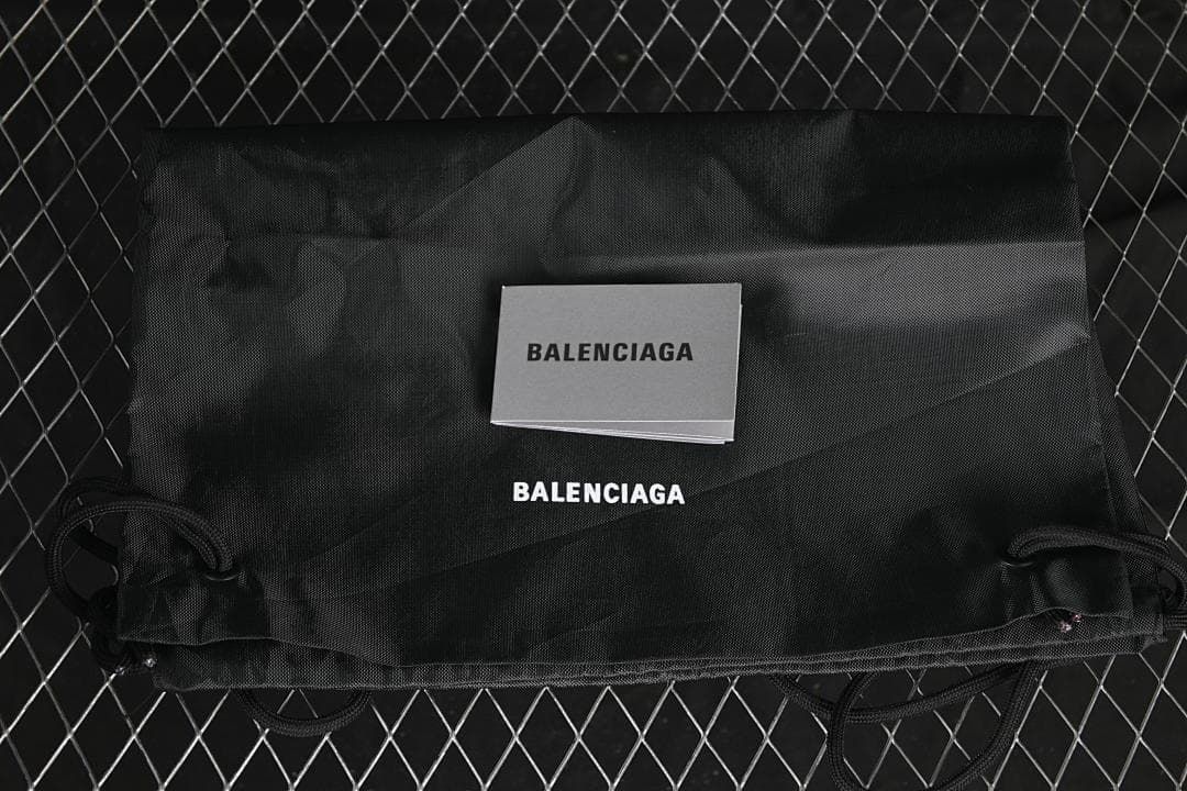 Black Balenciaga-branded dust bag and booklet
