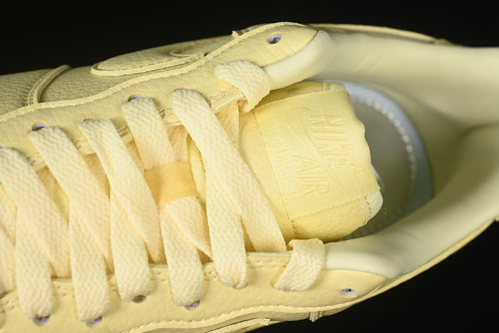 Close-up of pale yellow laces and tongue