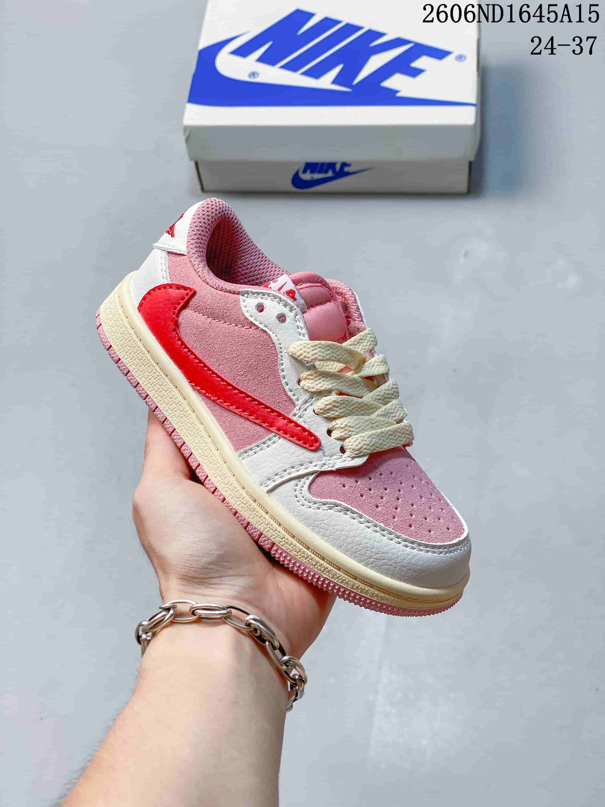 Side view of a pink and white kids’ low-top sneaker with a red side detail.